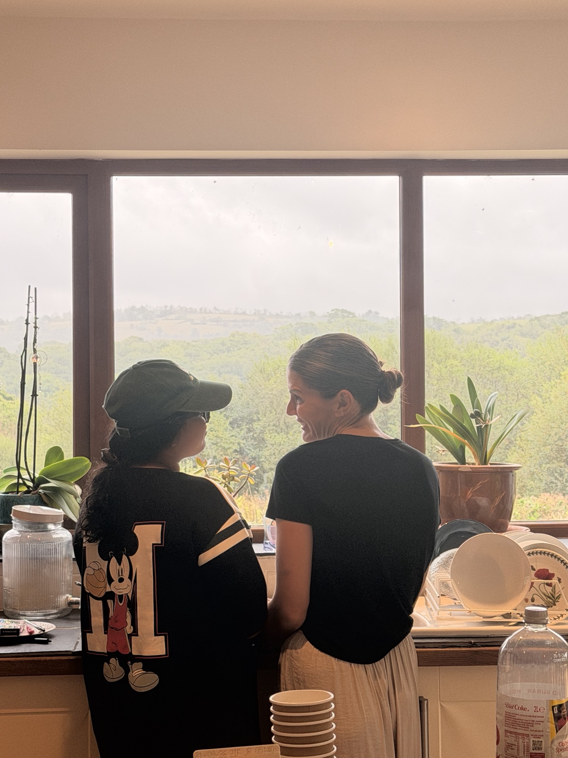 Two retreat guests talking by a window
